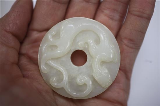 A Chinese white jade bi disc, diameter 4.6cm, wood stand